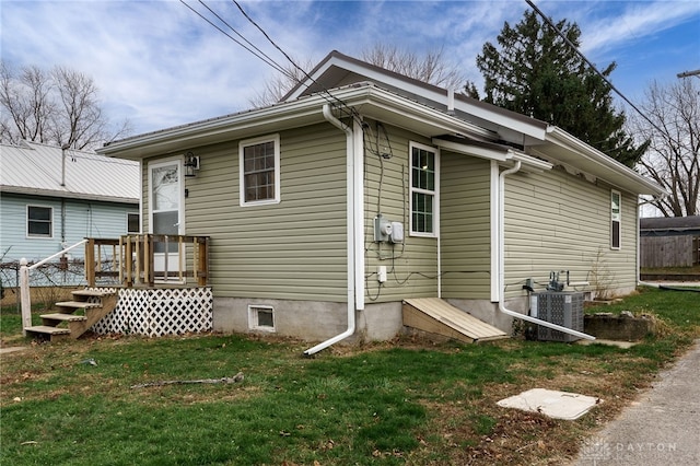 exterior space featuring a lawn and central AC