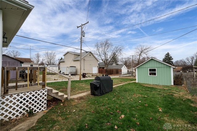 view of yard featuring a storage shed and a deck