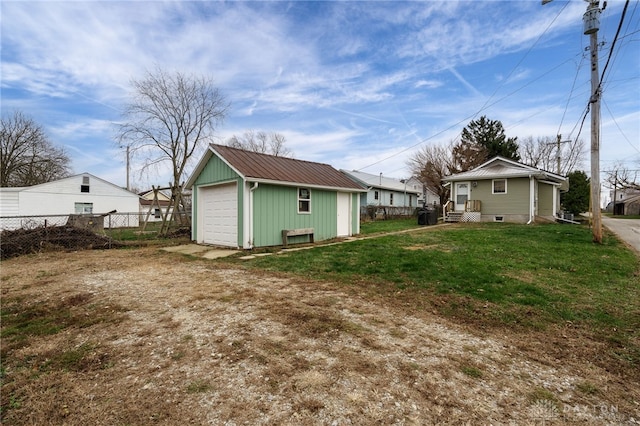 rear view of property with an outdoor structure and a lawn