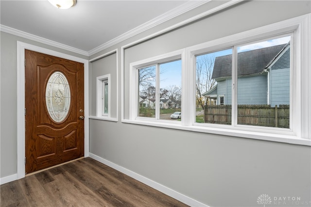 entrance foyer featuring baseboards, dark wood-style floors, and crown molding