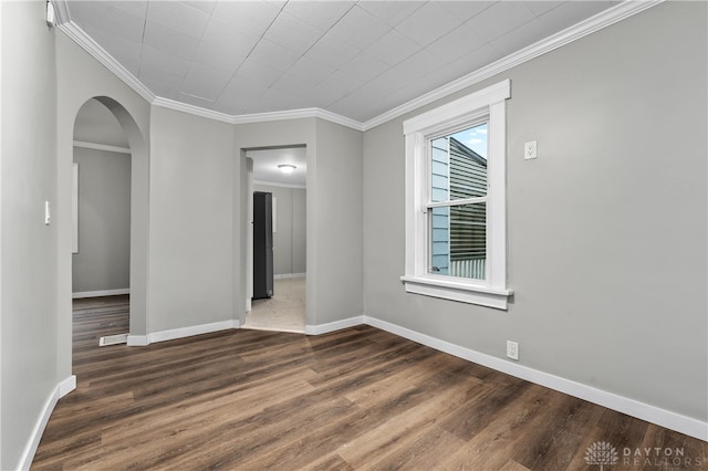 unfurnished room featuring crown molding and dark wood-type flooring