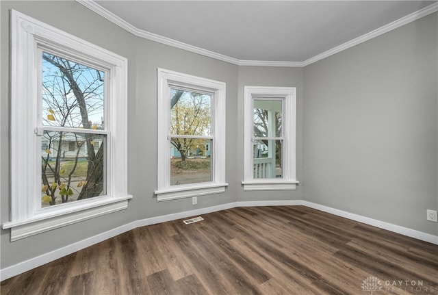 spare room featuring wood-type flooring and crown molding