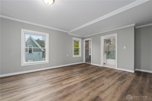 unfurnished room with hardwood / wood-style floors, ornamental molding, and a healthy amount of sunlight