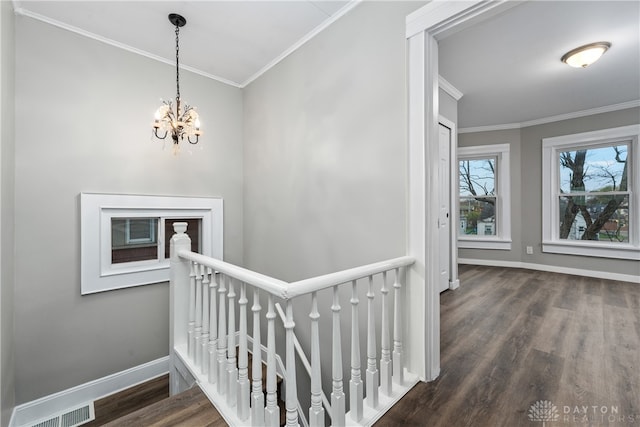 interior space featuring a notable chandelier, wood-type flooring, and crown molding