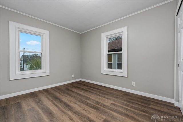 empty room featuring crown molding and dark wood-type flooring