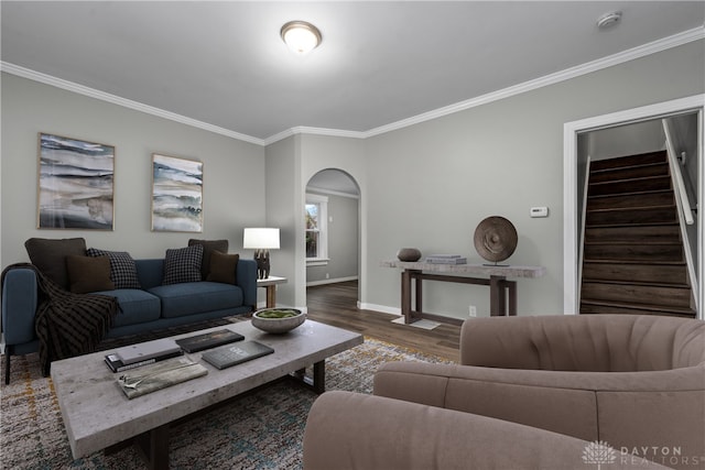 living room with stairs, arched walkways, and ornamental molding