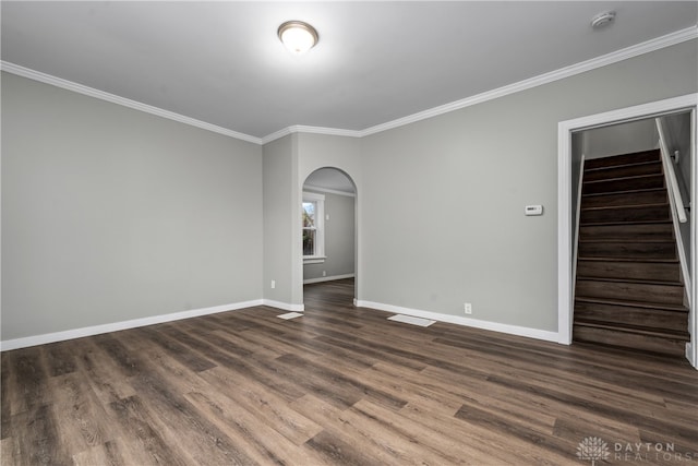 empty room featuring dark hardwood / wood-style flooring and crown molding