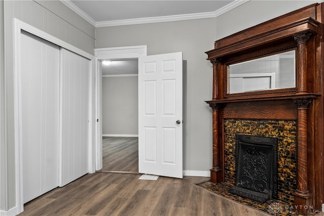 unfurnished living room featuring a fireplace, hardwood / wood-style flooring, and ornamental molding