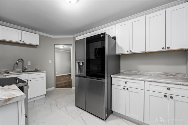 kitchen featuring fridge with ice dispenser, white cabinetry, and stainless steel electric range