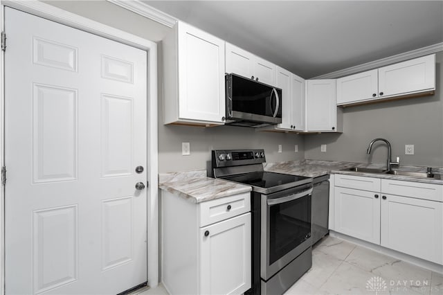 kitchen with light stone counters, sink, white cabinets, and appliances with stainless steel finishes