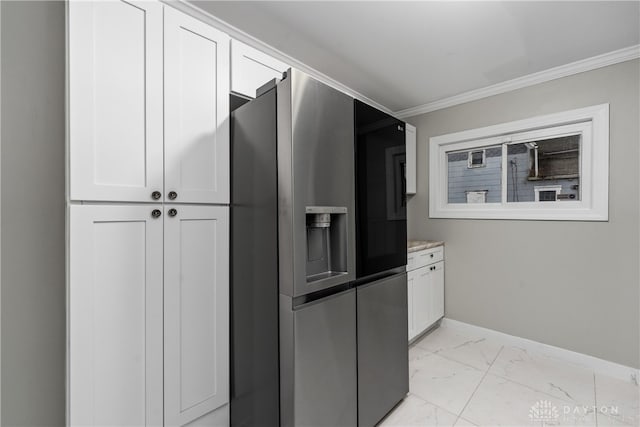 kitchen with stainless steel fridge, white cabinetry, and crown molding