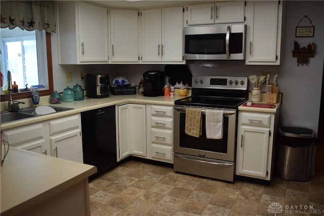 kitchen with white cabinets, sink, and appliances with stainless steel finishes