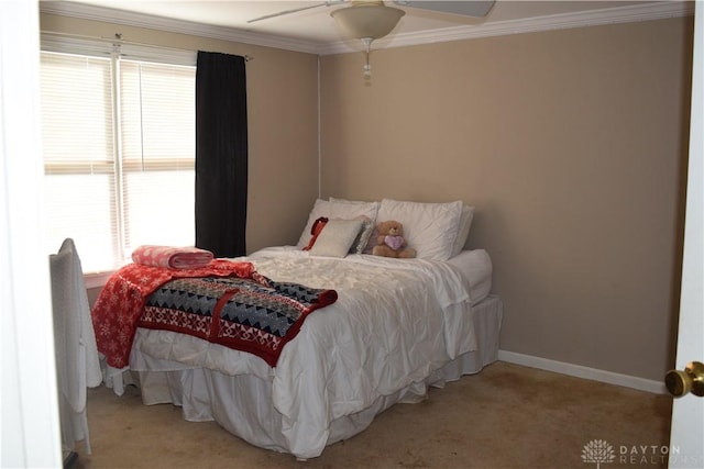 carpeted bedroom with ceiling fan and ornamental molding