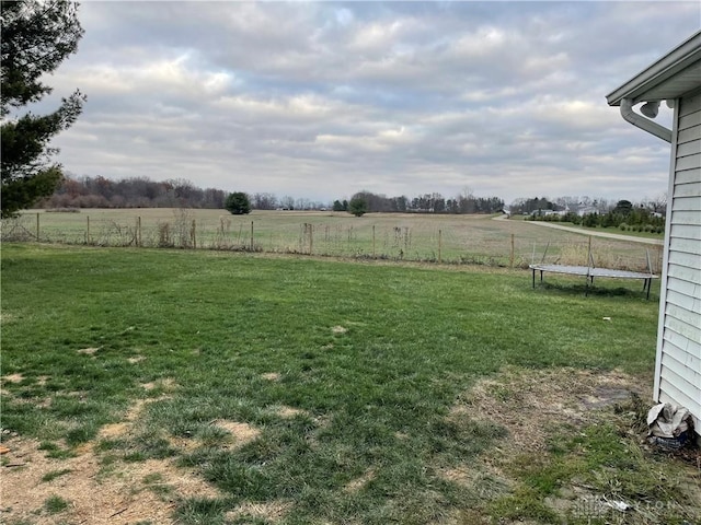 view of yard with a rural view and a trampoline