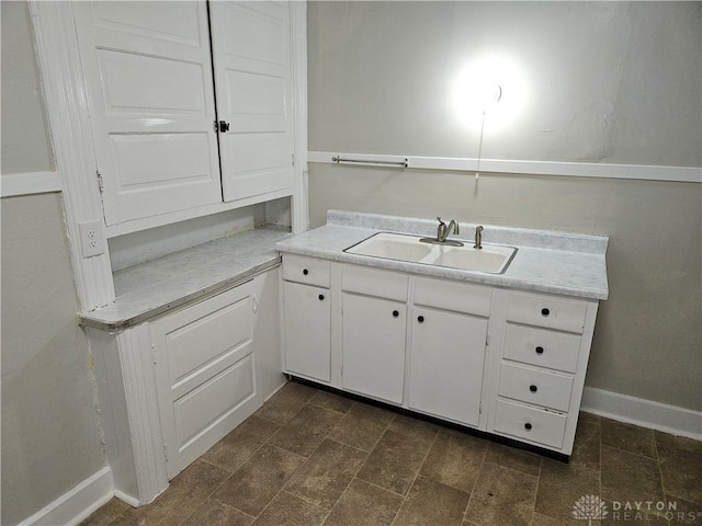 kitchen with white cabinetry and sink