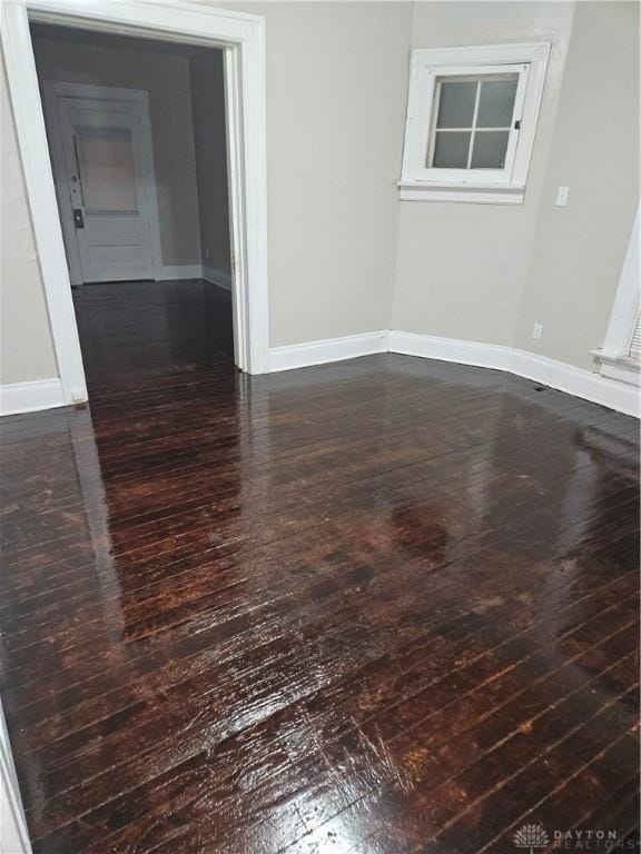 empty room with dark wood-type flooring