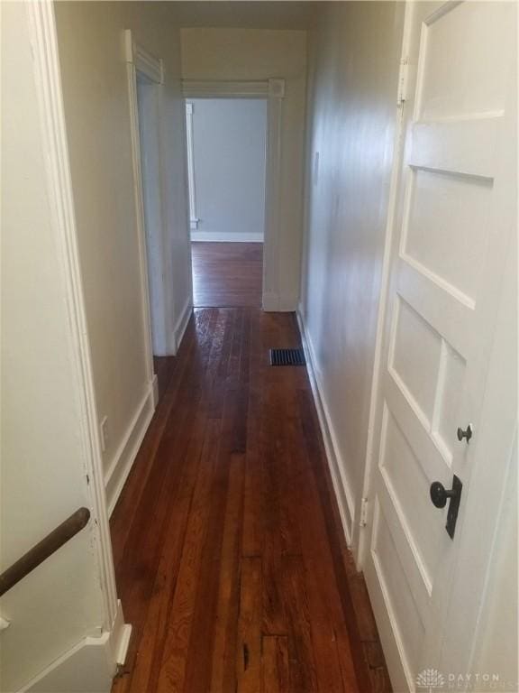 corridor with dark hardwood / wood-style floors