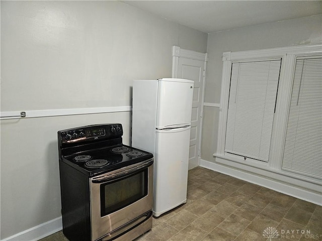 kitchen featuring electric stove and white fridge