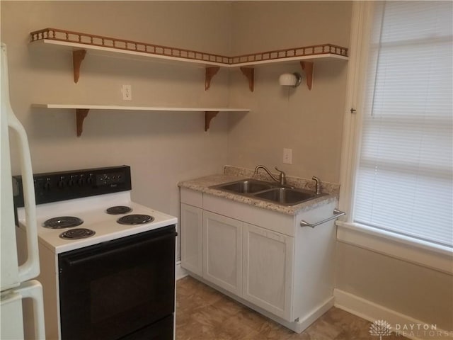 kitchen featuring white cabinets, white appliances, and sink