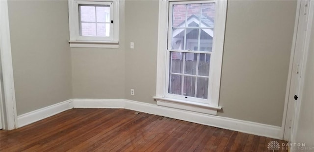 empty room with dark hardwood / wood-style floors