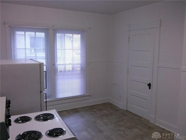 kitchen with white cabinetry and white range with electric cooktop