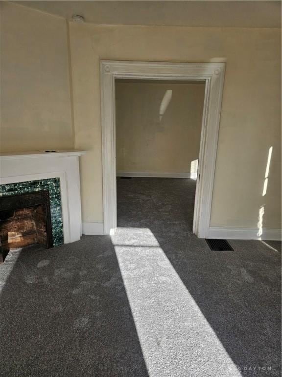 carpeted living room featuring a fireplace