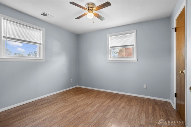 empty room with light hardwood / wood-style floors and ceiling fan