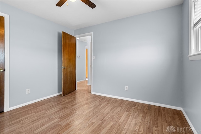 spare room with light hardwood / wood-style flooring and ceiling fan