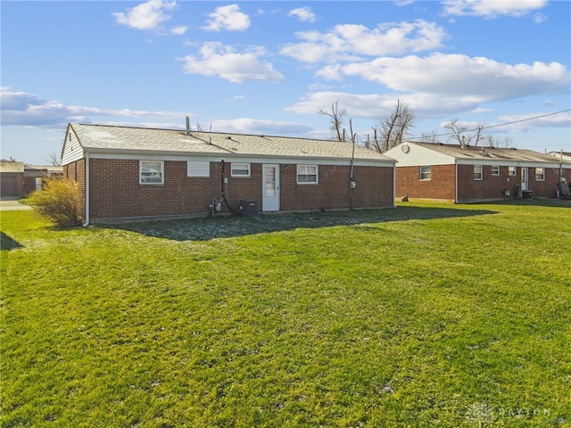 rear view of property with a yard