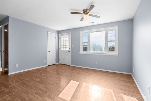 interior space with ceiling fan, a textured ceiling, and hardwood / wood-style flooring