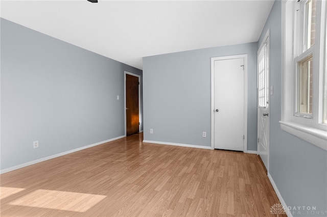 unfurnished room featuring a healthy amount of sunlight and light wood-type flooring