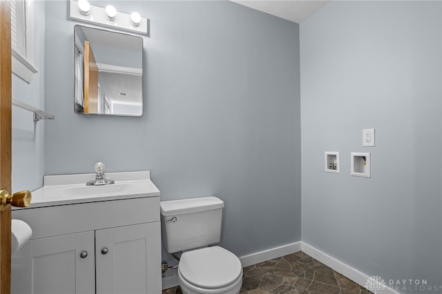 bathroom featuring tile patterned flooring, vanity, and toilet