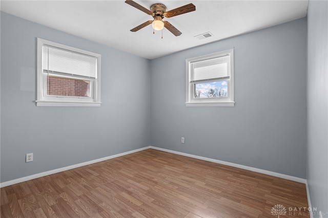 spare room featuring light hardwood / wood-style floors and ceiling fan