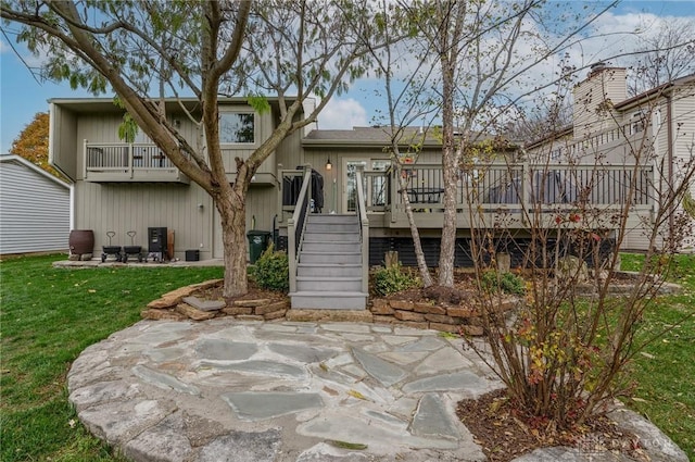 back of house with a yard, a deck, and a patio area