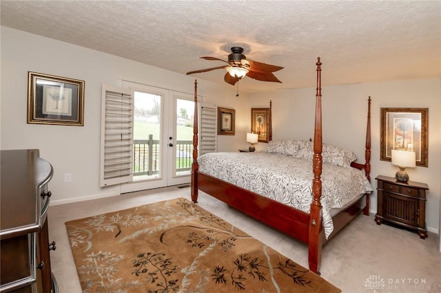 carpeted bedroom featuring ceiling fan, a textured ceiling, access to outside, and french doors