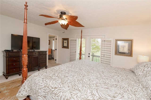 bedroom featuring access to exterior, light carpet, a textured ceiling, and ceiling fan