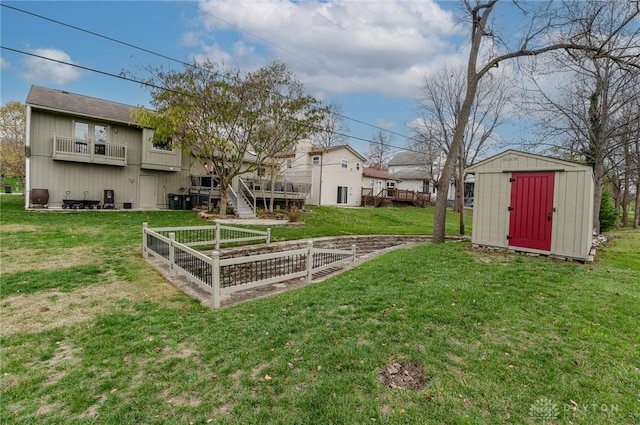 view of yard with a shed and a balcony