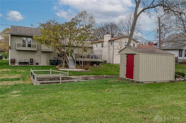 view of yard with a balcony and a shed