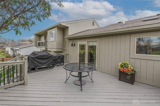 wooden terrace featuring a grill