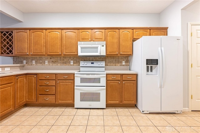 kitchen with decorative backsplash, light tile patterned floors, white appliances, and sink