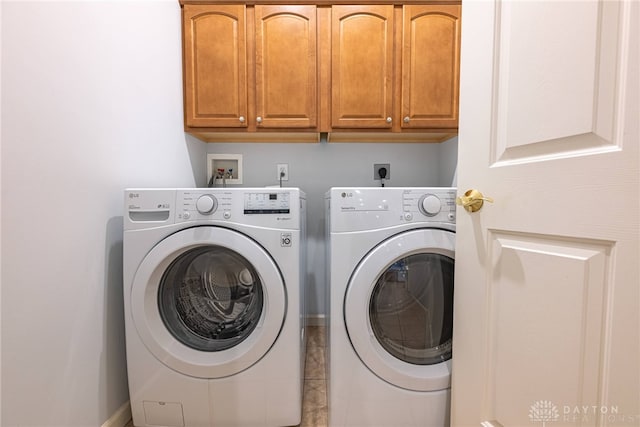 laundry area featuring washing machine and dryer and cabinets