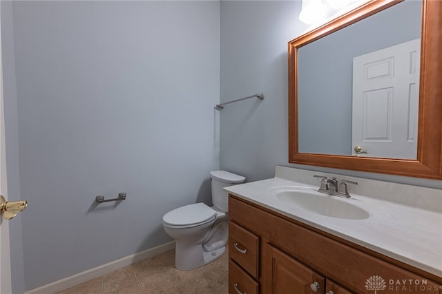 bathroom featuring tile patterned flooring, vanity, and toilet