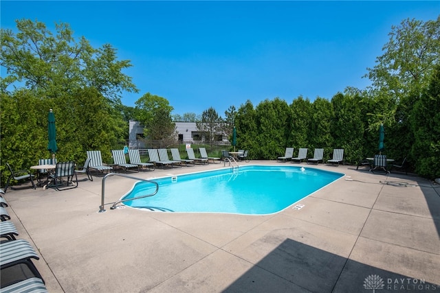 view of swimming pool with a patio