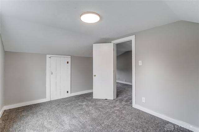 additional living space featuring carpet flooring and vaulted ceiling