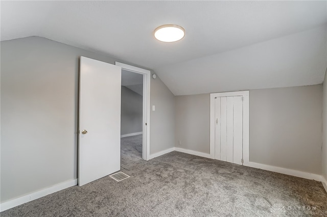 bonus room with carpet flooring and lofted ceiling