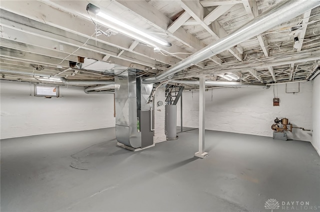 basement featuring gas water heater and heating unit