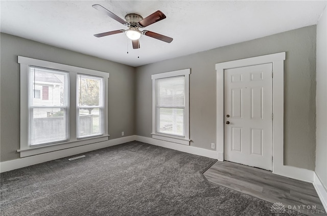 interior space featuring ceiling fan and dark hardwood / wood-style flooring