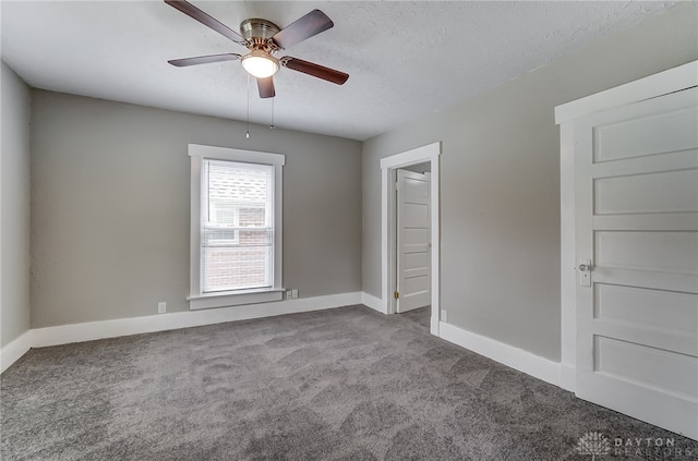 spare room with carpet flooring, ceiling fan, and a textured ceiling