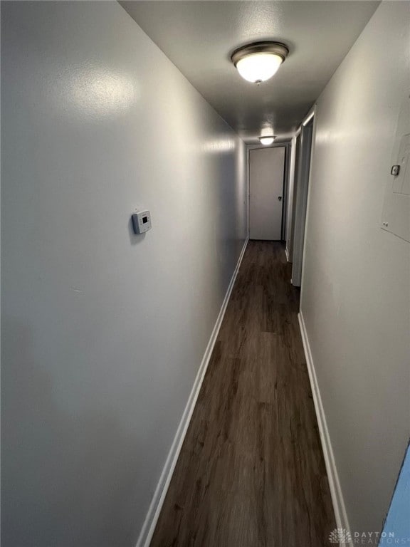 hallway with dark hardwood / wood-style flooring