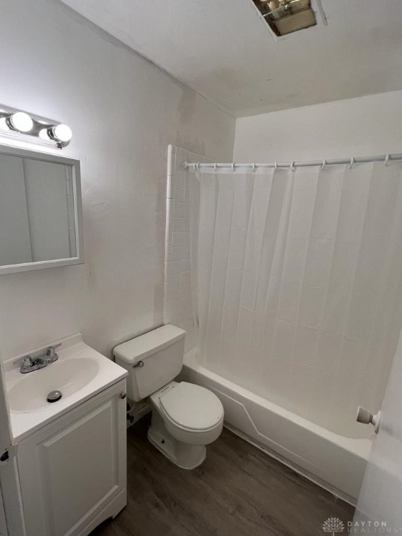 full bathroom featuring shower / bathtub combination with curtain, vanity, wood-type flooring, and toilet